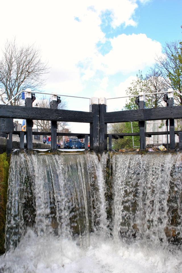 Water cascading over the lock gate at the first Lock on the Royal Canal, Ireland. As seen from the deck of JT's 4E.